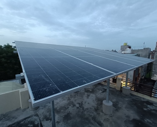 Angled view of a completed rooftop solar array on a residential building