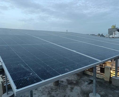 Close view of an installed rooftop solar panel array at dusk