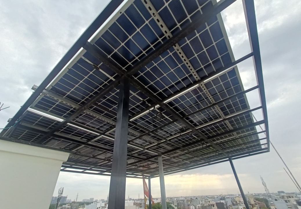 Underside view of an elevated galvanised steel mounting structure carrying a rooftop solar array